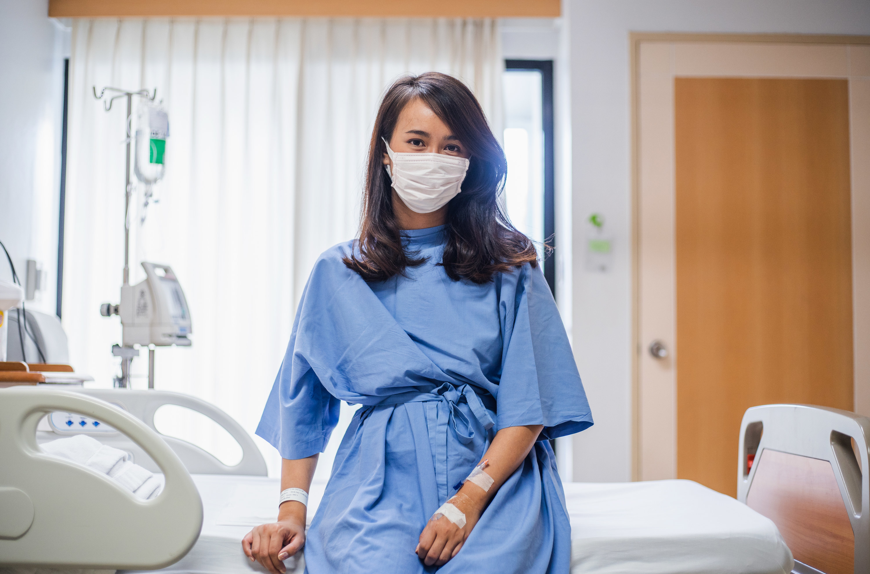 Young woman sitting on a hospital bed