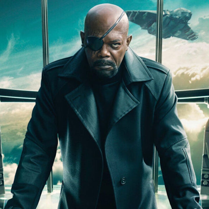 Nick Fury leans over a table 