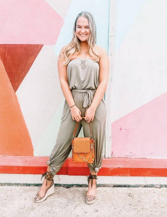 reviewer wearing the olive green jumpsuit with ankle ties 