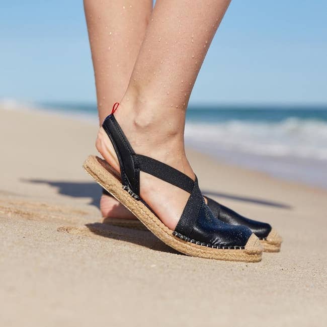 model wearing waterproof espadrilles with slingback design on the beach