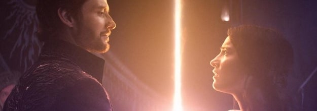 The Darkling and Alina look at each other as a light beam shoots up from Alina's arm