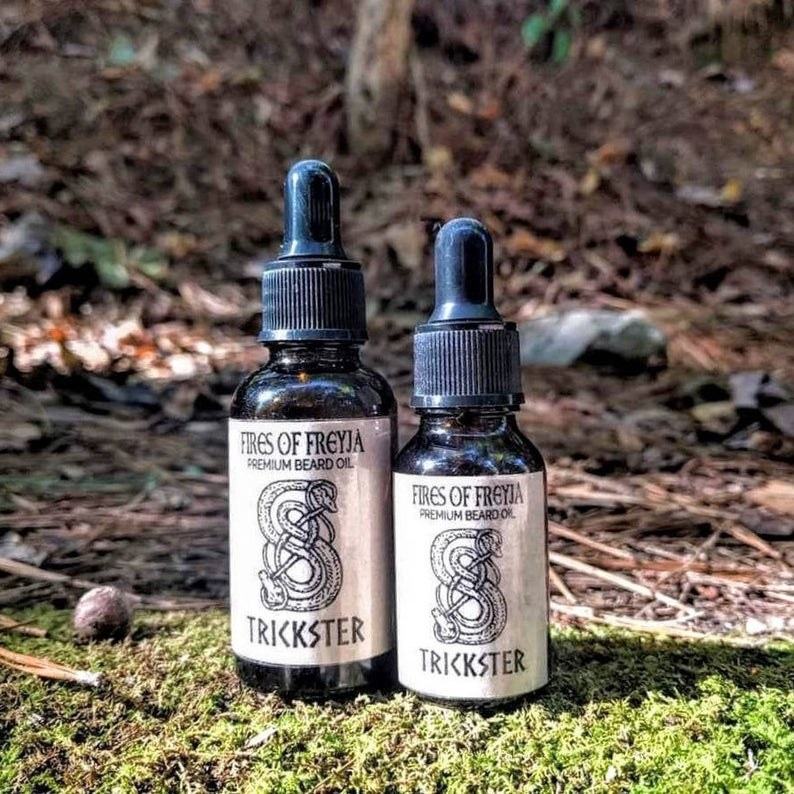 bottles of the &quot;Trickster&quot; beard oil with Loki&#x27;s symbol