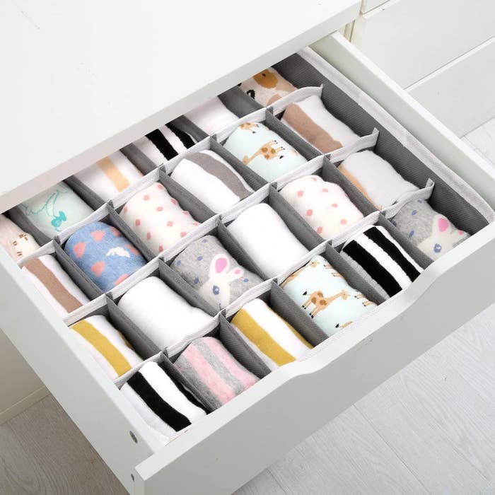 An open drawer with a grid-like organizer inside
