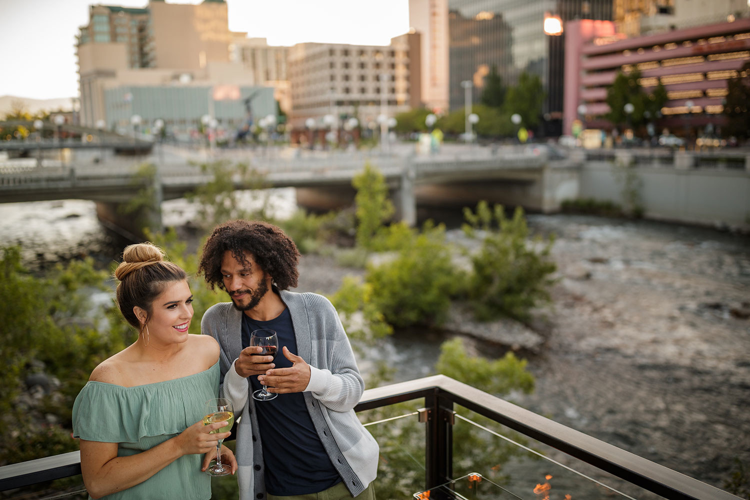 A couple enjoys wine at a restaurant on the Truckee River