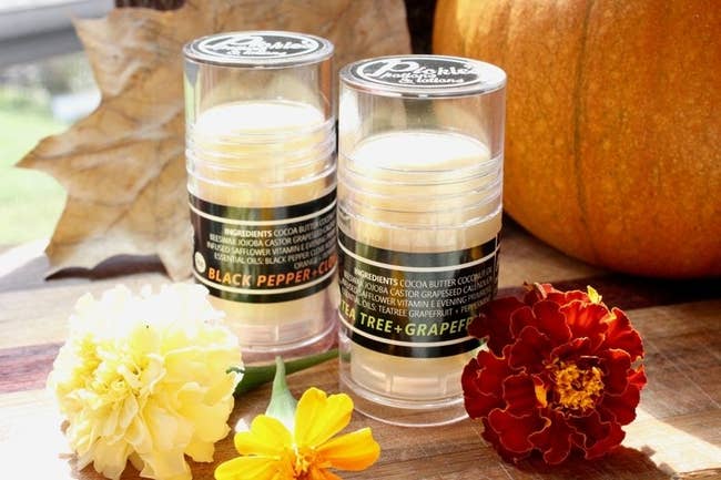 Two large tubes of the balm in the black pepper and clove and tea tree and grapefruit versions