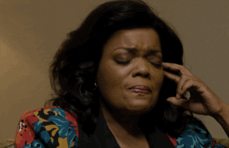 Emotional Yvette Nicole Brown closing her eyes