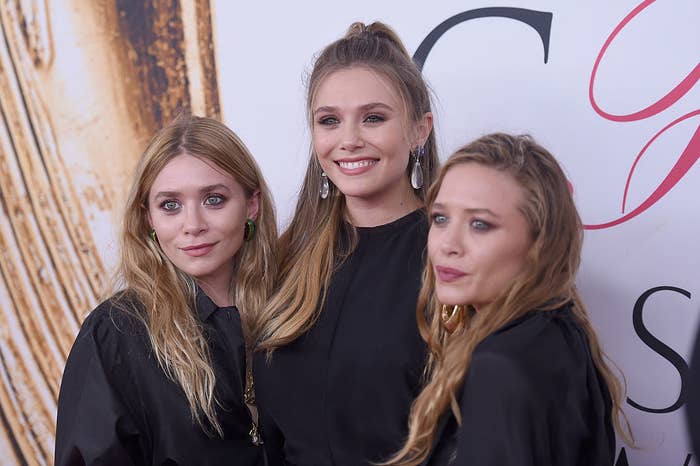 Elizabeth posing on a red carpet with her sisters