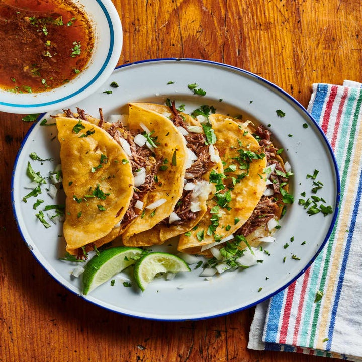 Birria tacos with broth on the side.