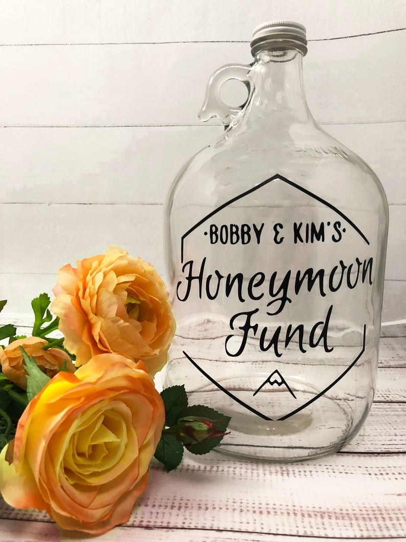 The customizable fund jar that features the couple&#x27;s names and the words &quot;honeymoon fund&quot;