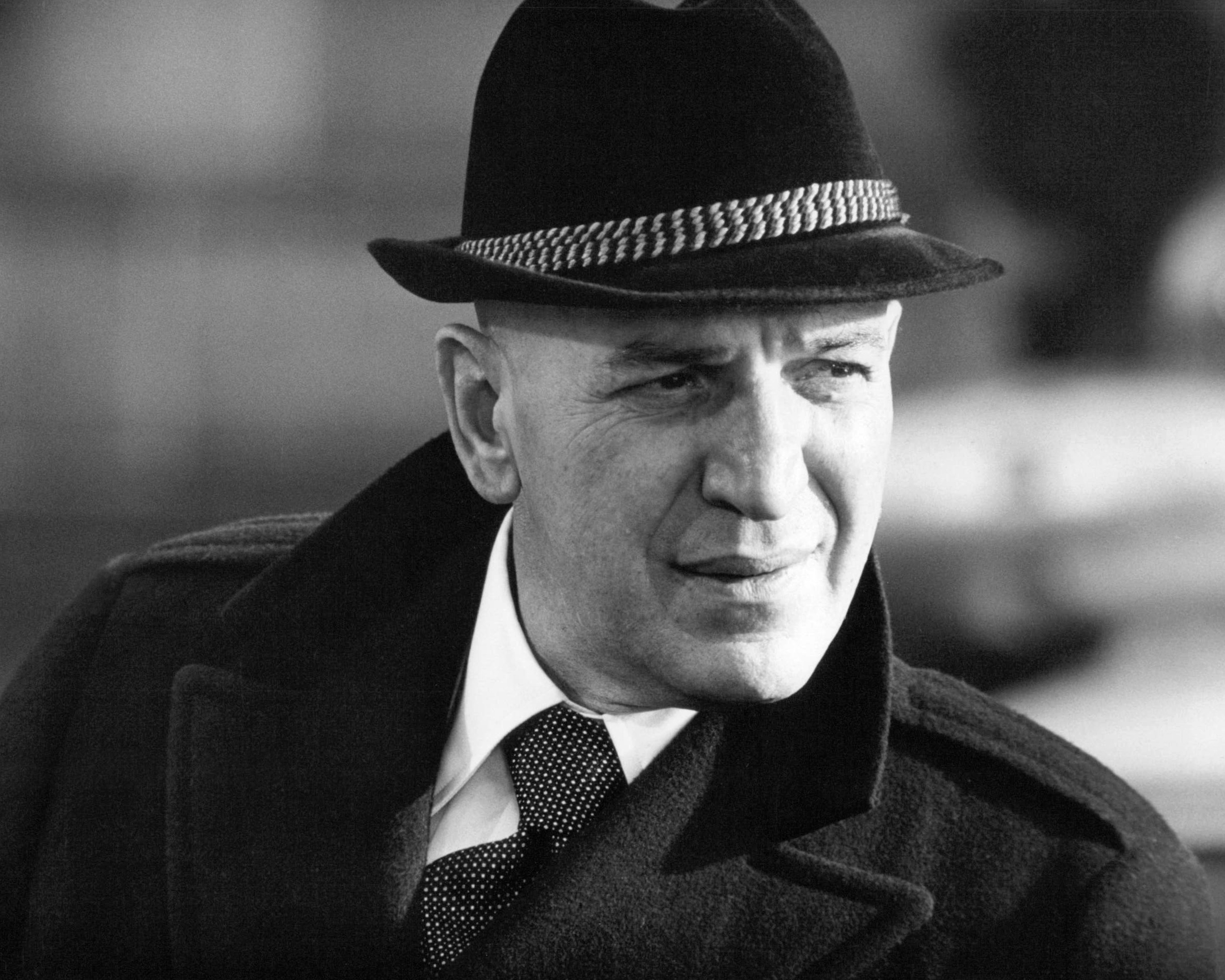 Black-and-white photo of Telly Savalas wearing a hat