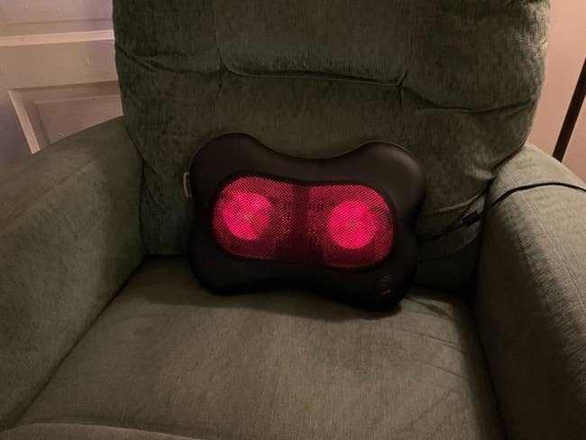 the massager lit up sitting on reviewer's arm chair