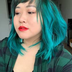 reviewer with bright teal hair that's shoulder length 