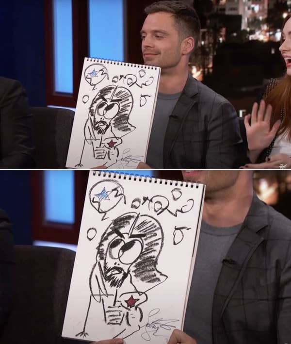 Sebastian holding up his drawing of Bucky and smiling