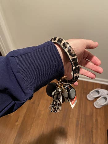 reviewer wearing the keyring bangle in leopard