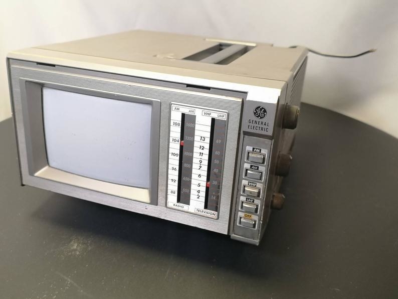A grey GE portable TV from the &#x27;80s on a table top