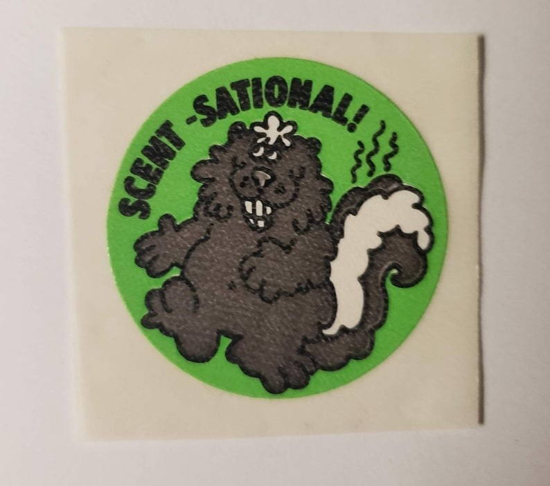 A photo a skunk sticker with Scent-Sational! written above the cartoon skunk