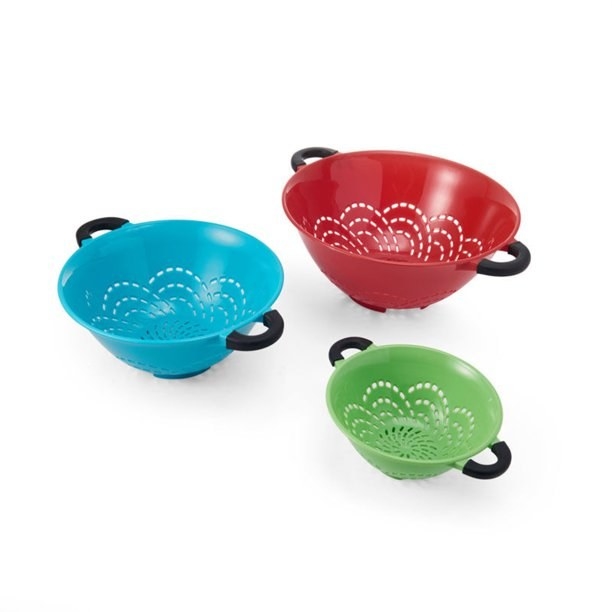 The colanders, which come in three sizes and three colors —large/ blue, medium/ red, and small/ green