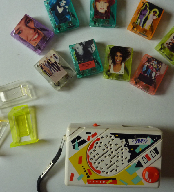 A Pocket Rocker on table surrounded by various mini-tapes