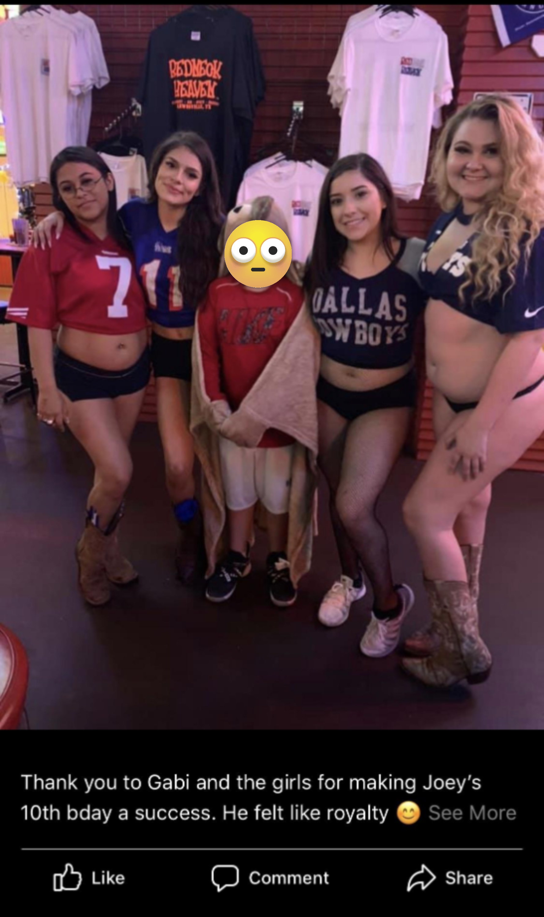 A boy is surrounded by scantily clad waitresses