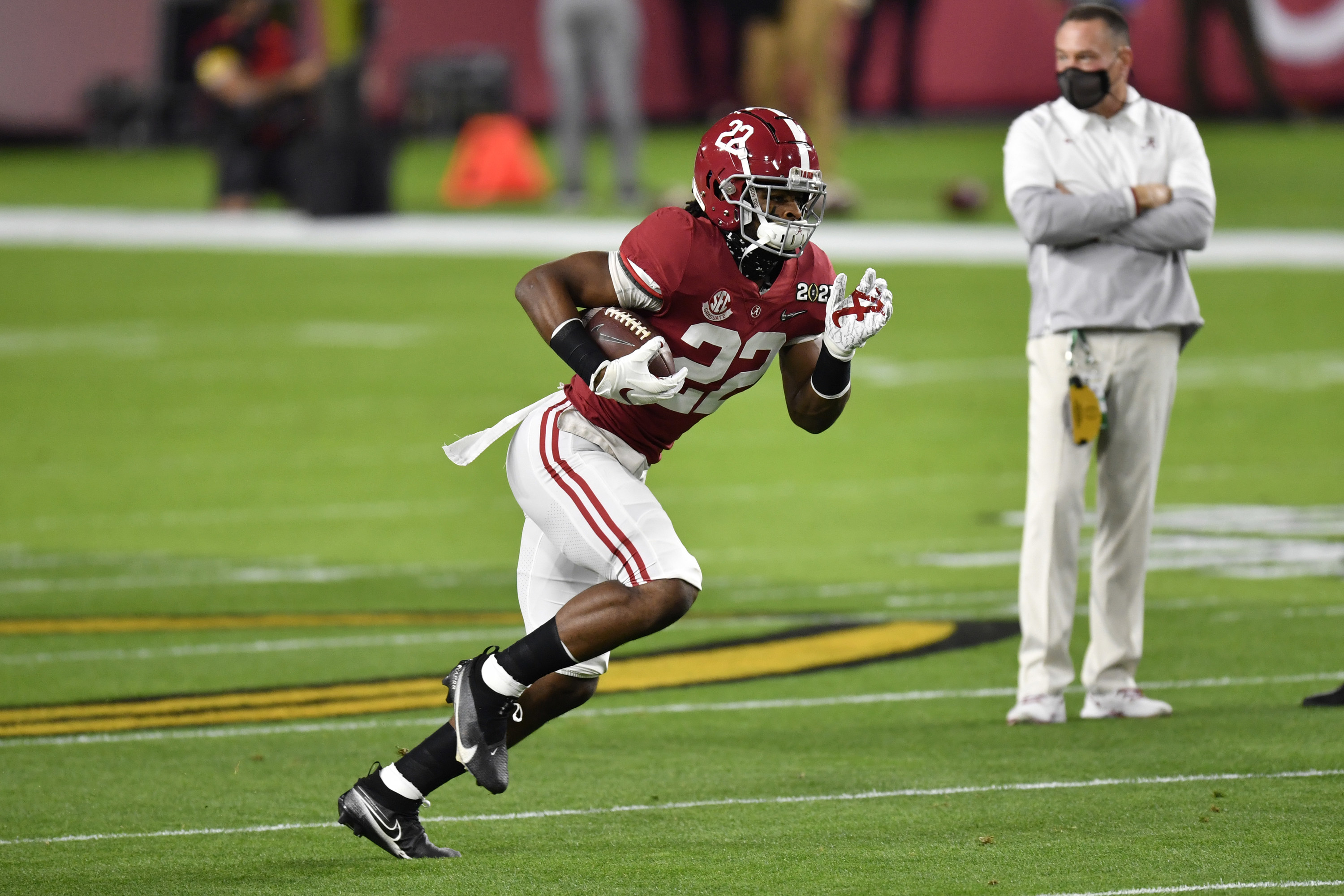 Najee Harris running with the football