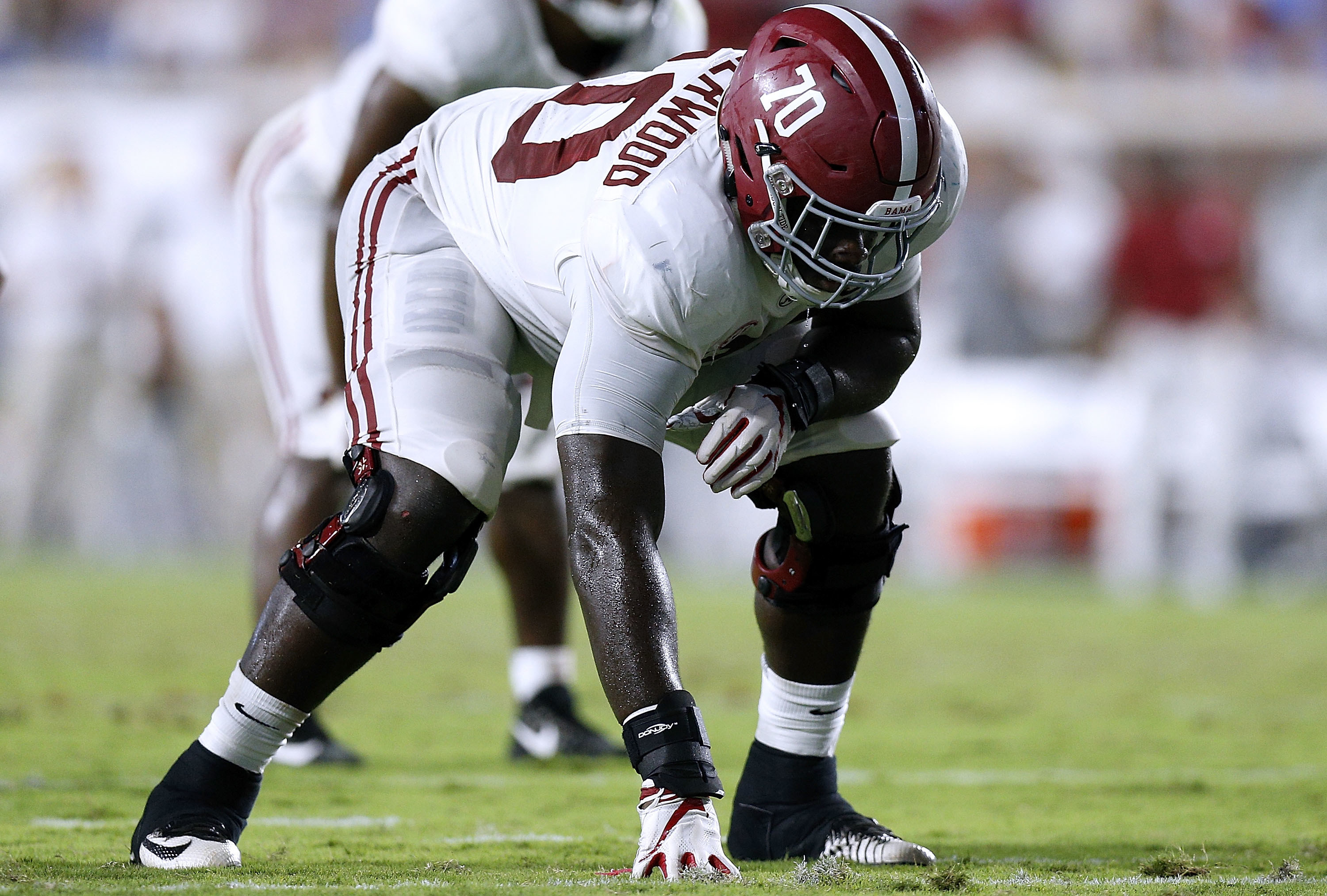 Alex Leatherwood standing in a three-point stance