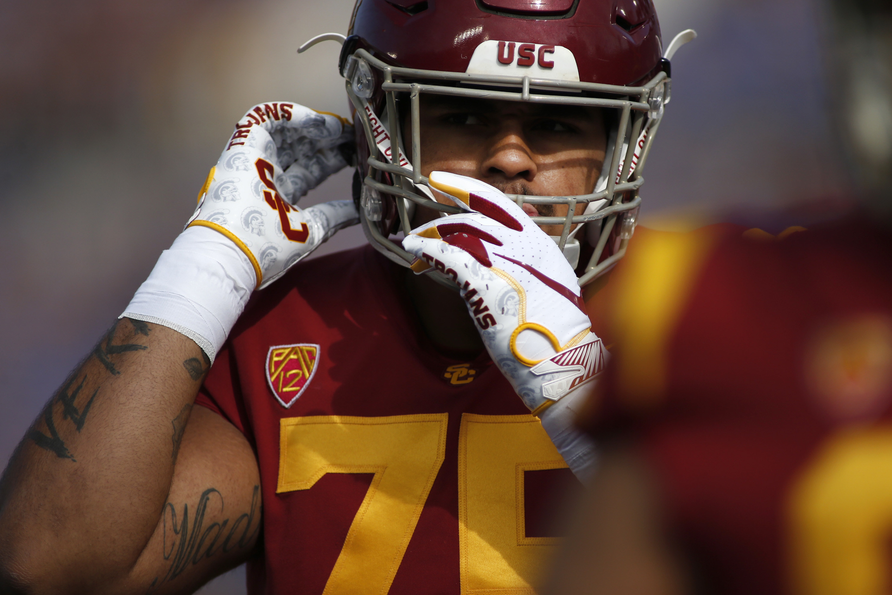 Alijah Vera-Tucker strapping facemask