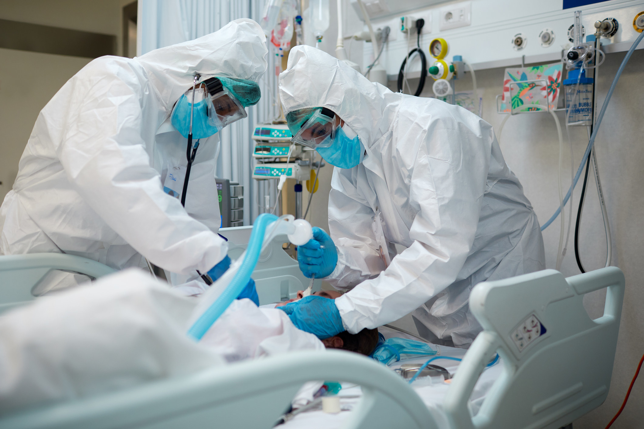 Two doctors helping someone with their ventilator