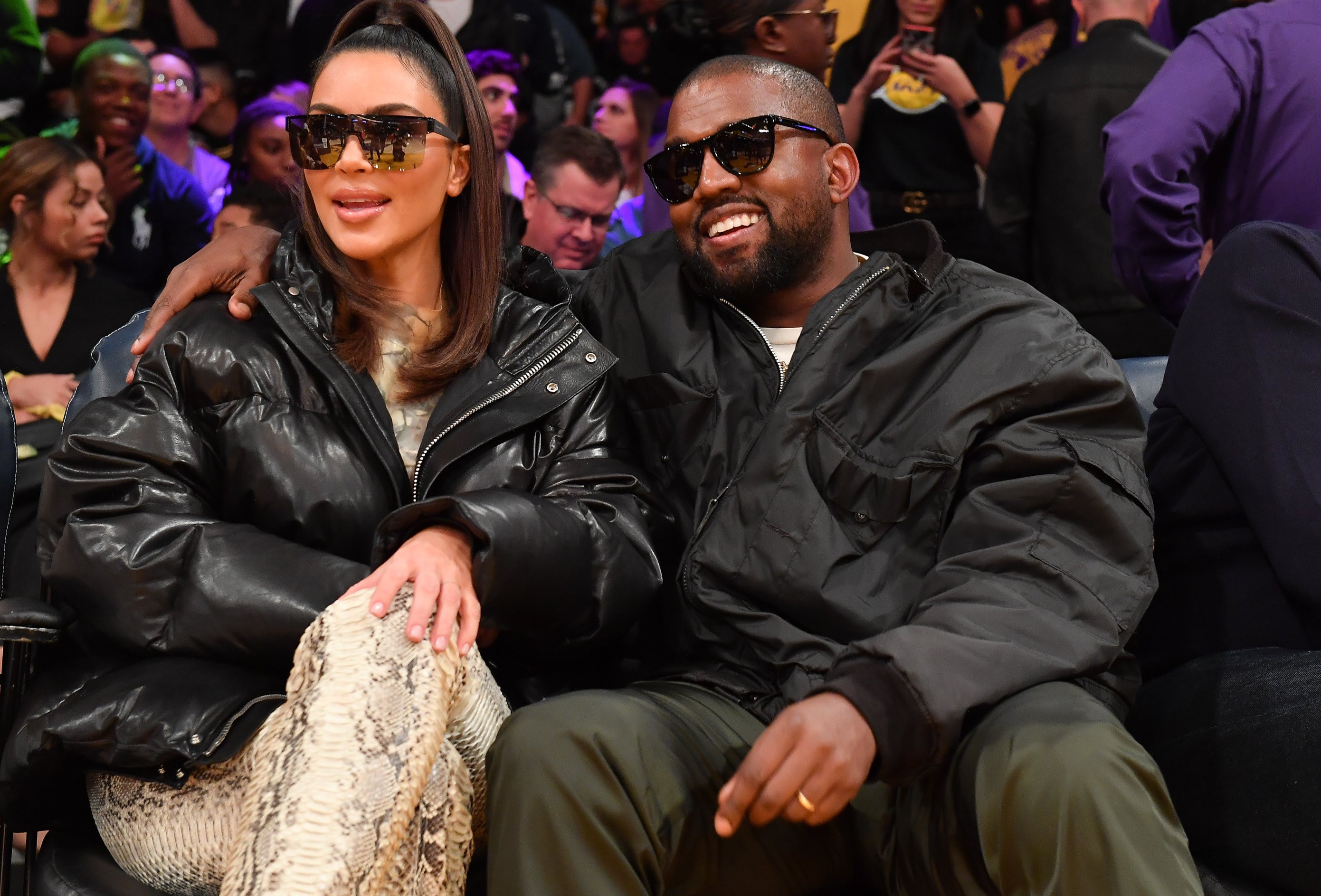 Kim and Kanye sit next to each other at a basketball game
