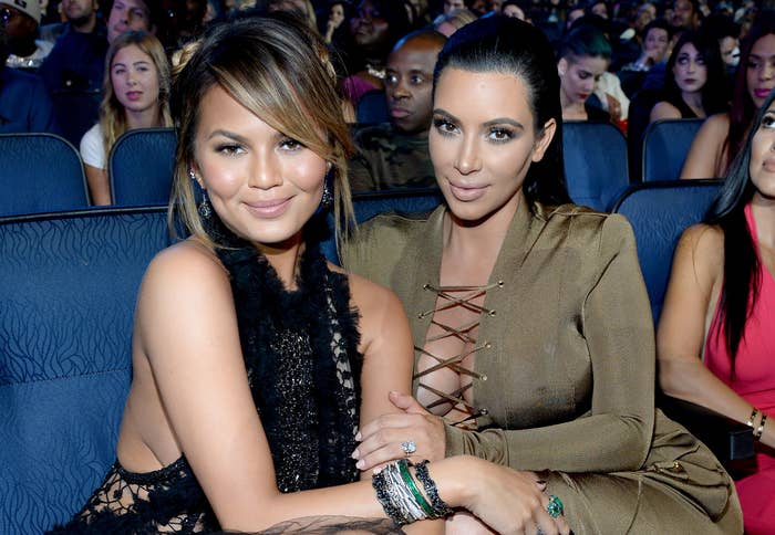 Chrissy and Kim hold on to each other at an awards show