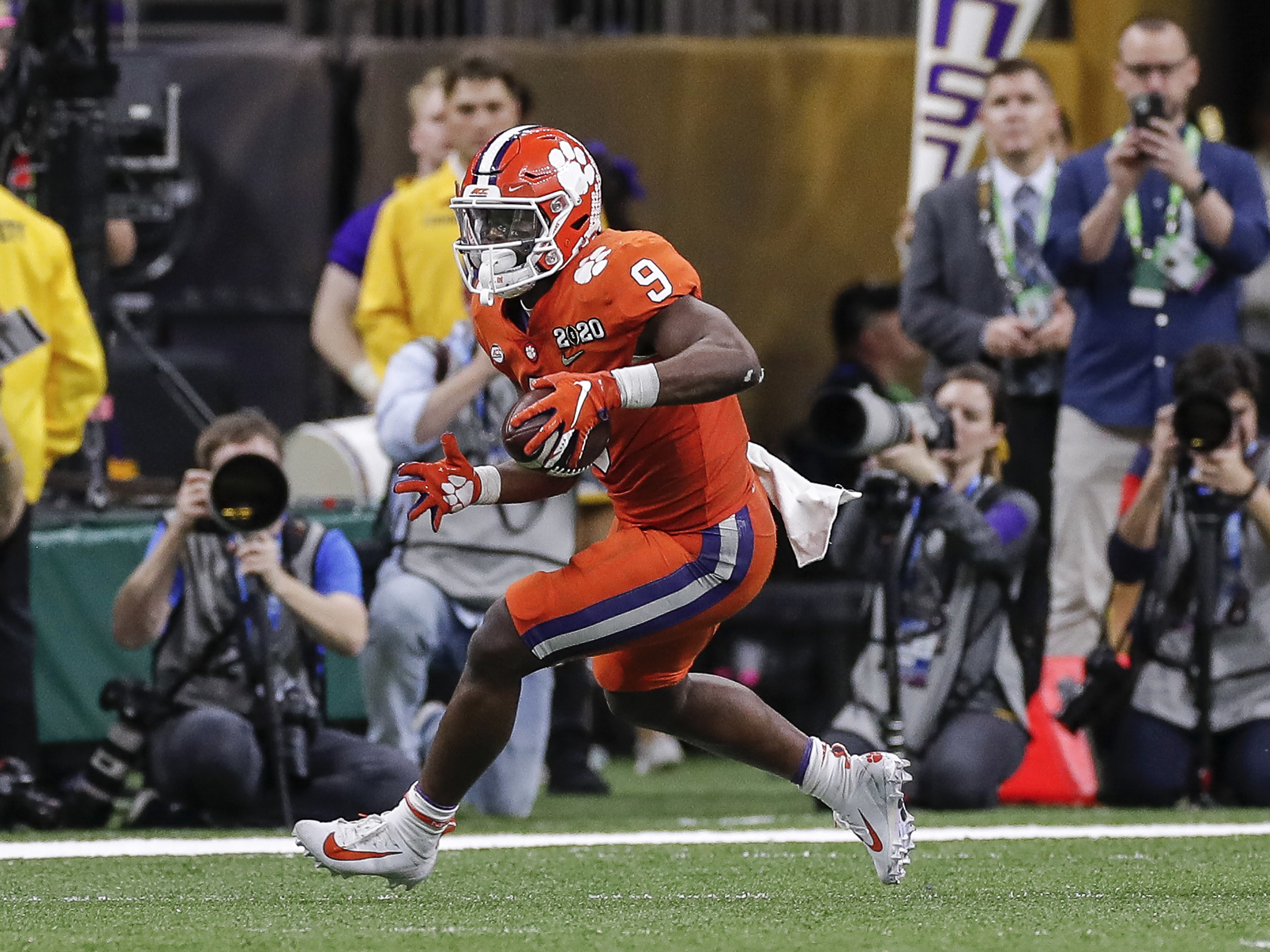 Travis Etienne running with the football