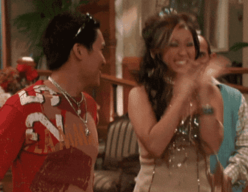 Dante Basco clapping and jumping with Brenda Song as London Tipton
