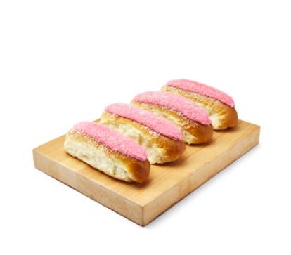A row of finger buns on a wooden chopping board