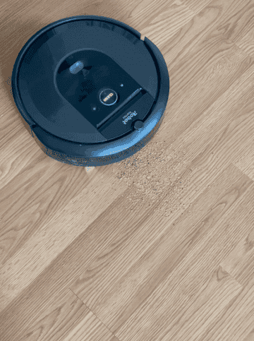 The Roomba cleaning a pile of dirt