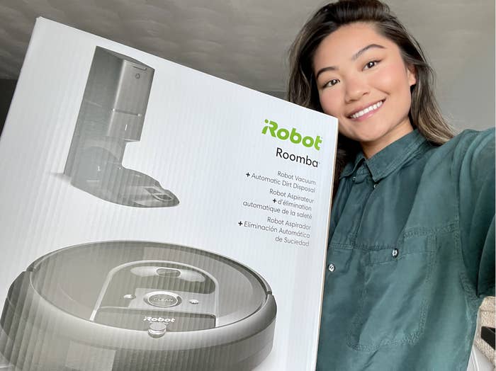 May holding the box for the iRobot Roomba i7+