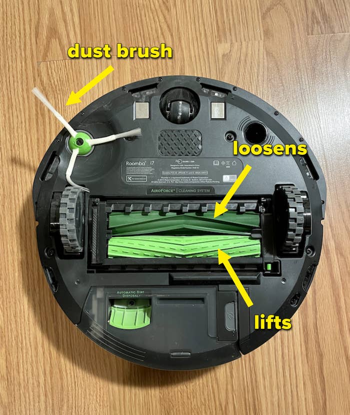 The underside of the Roomba i7+ where May labeled the dust brush and dirt loosening and lifting brushes