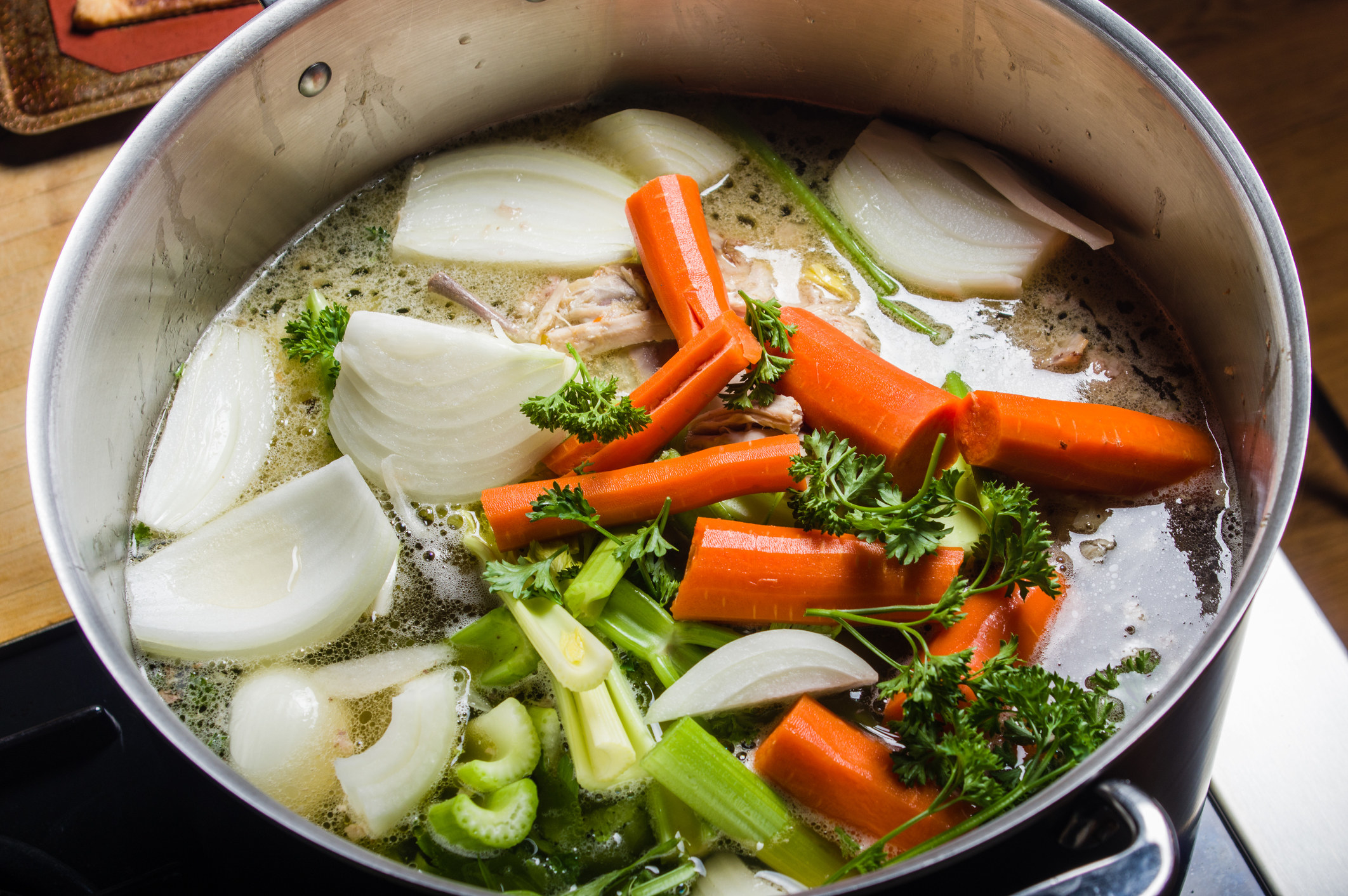A pot with veggies and bones for stock.