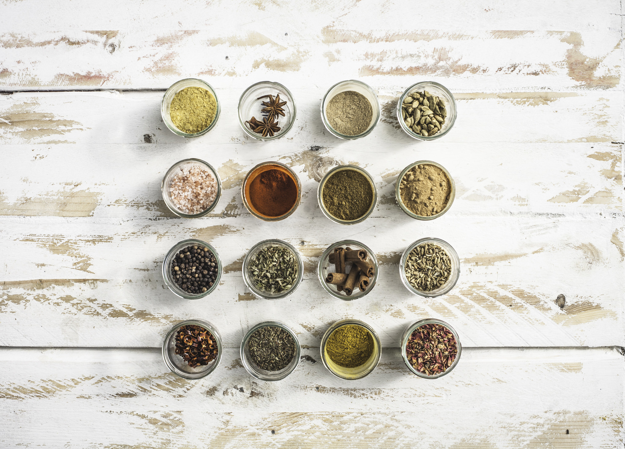 Different spices in small glass bowls.