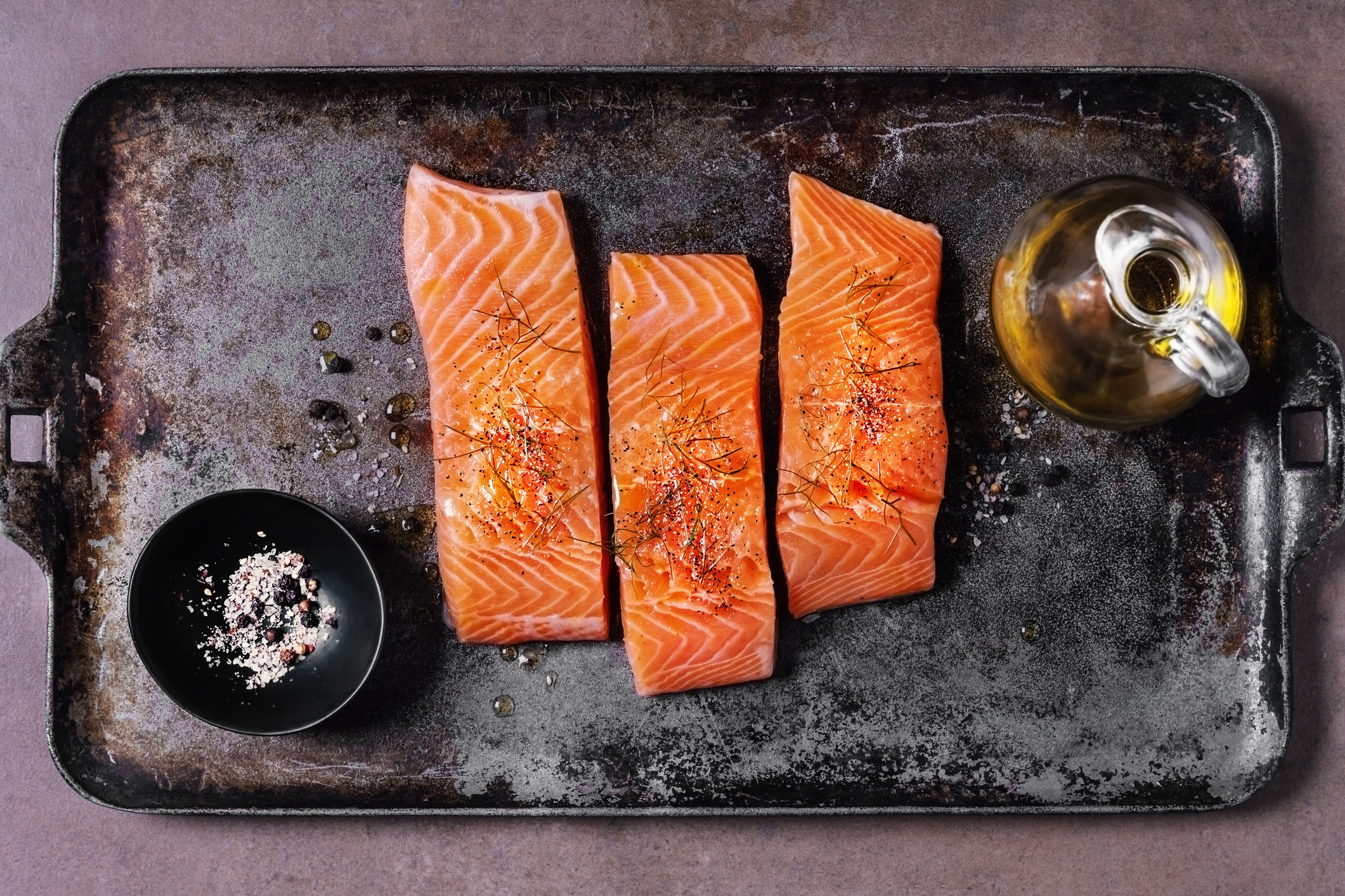 Raw salmon on a sheet pan.