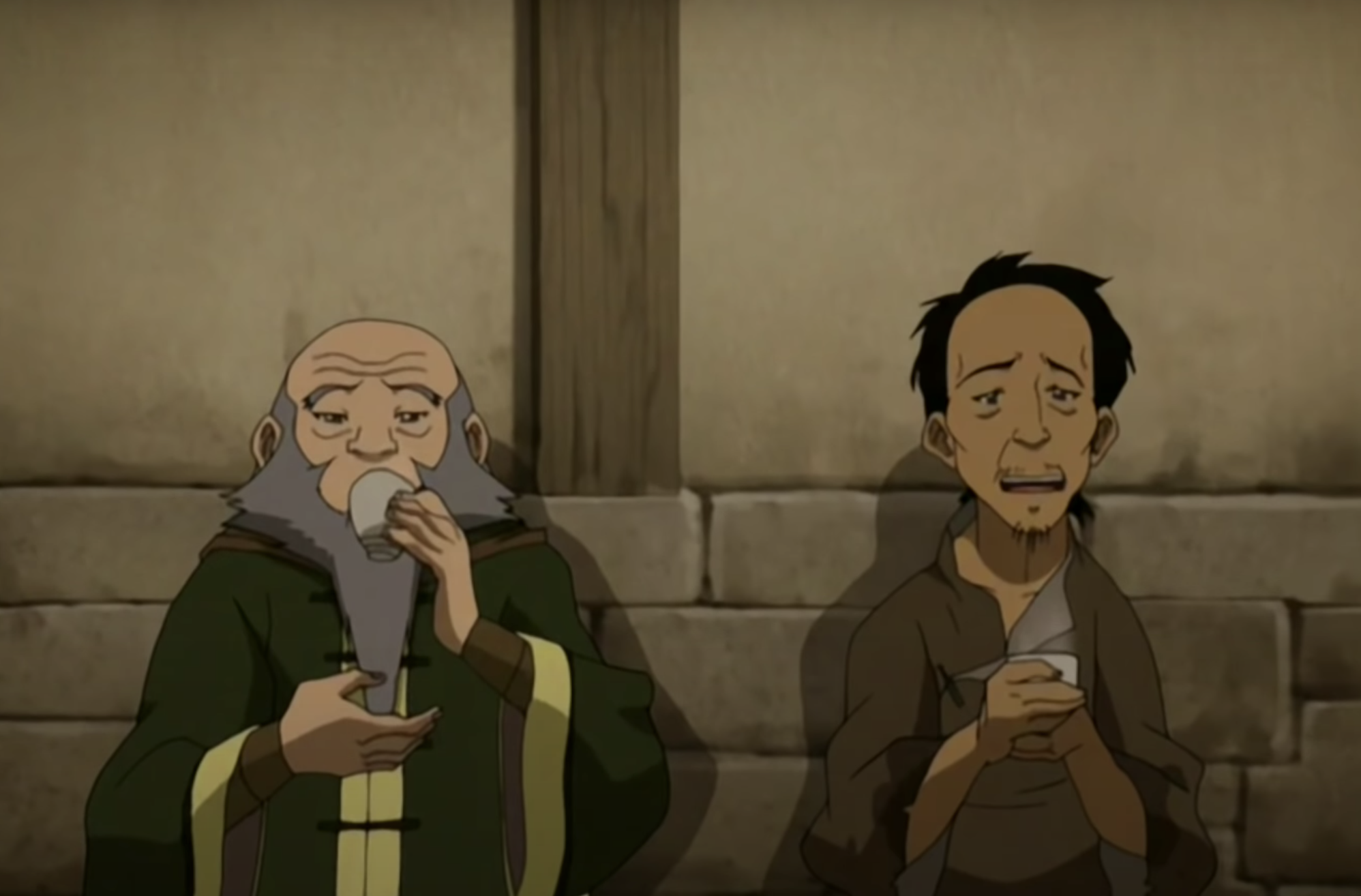 Iroh and a man who earlier tried to mug him drinking tea together