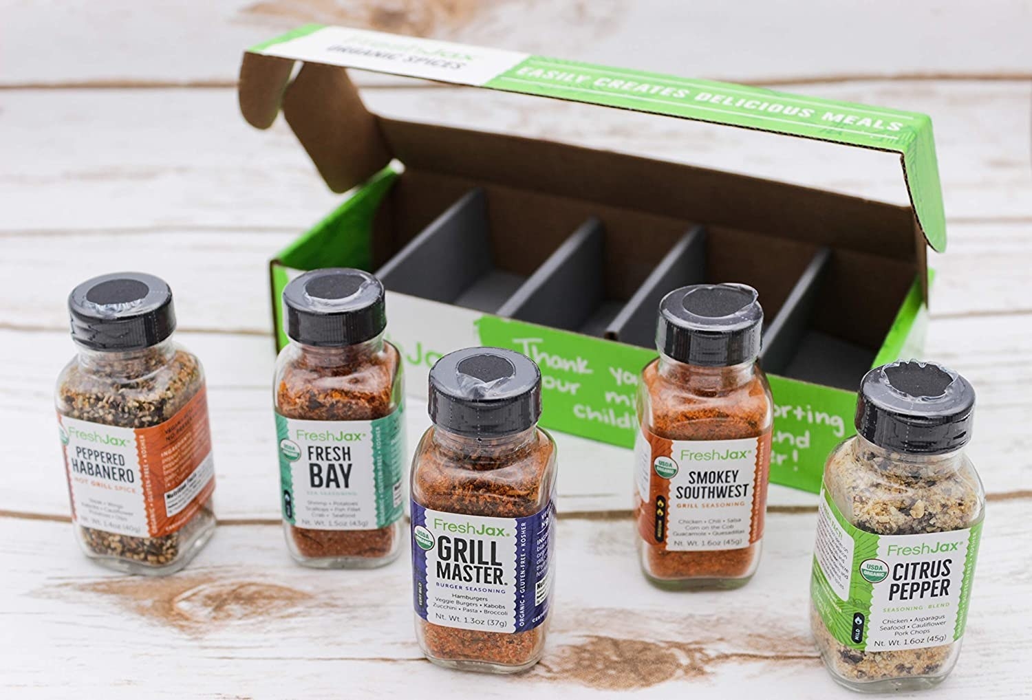 The grilling themed box, with five bottles of spices each labeled with their name and a short list of foods to try them on