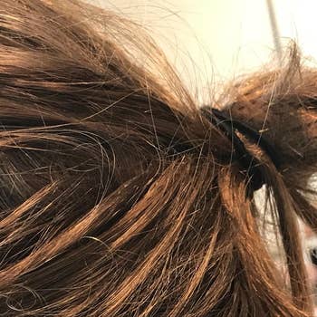 a reviewer photo of their hair in a messy bun using the hair ties
