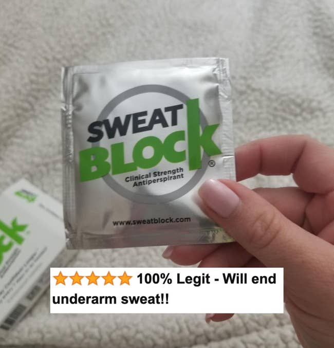reviewer image holding Sweat Block wipe packet 