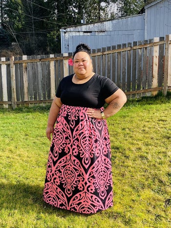 a reviewer in the empire dress's option with black on top and a pink and black floral-ish pattern on the bottom