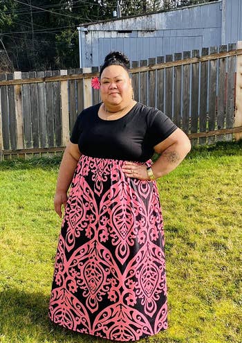 a reviewer in the empire dress's option with black on top and a pink and black floral-ish pattern on the bottom