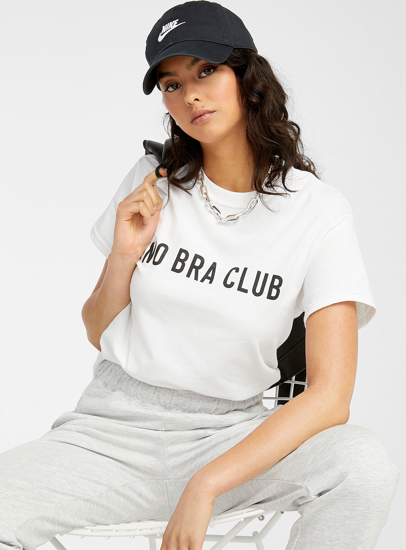 A person wearing a T-shirt that says no bra club