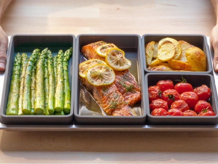 silicone dividers on baking sheet filled with different foods