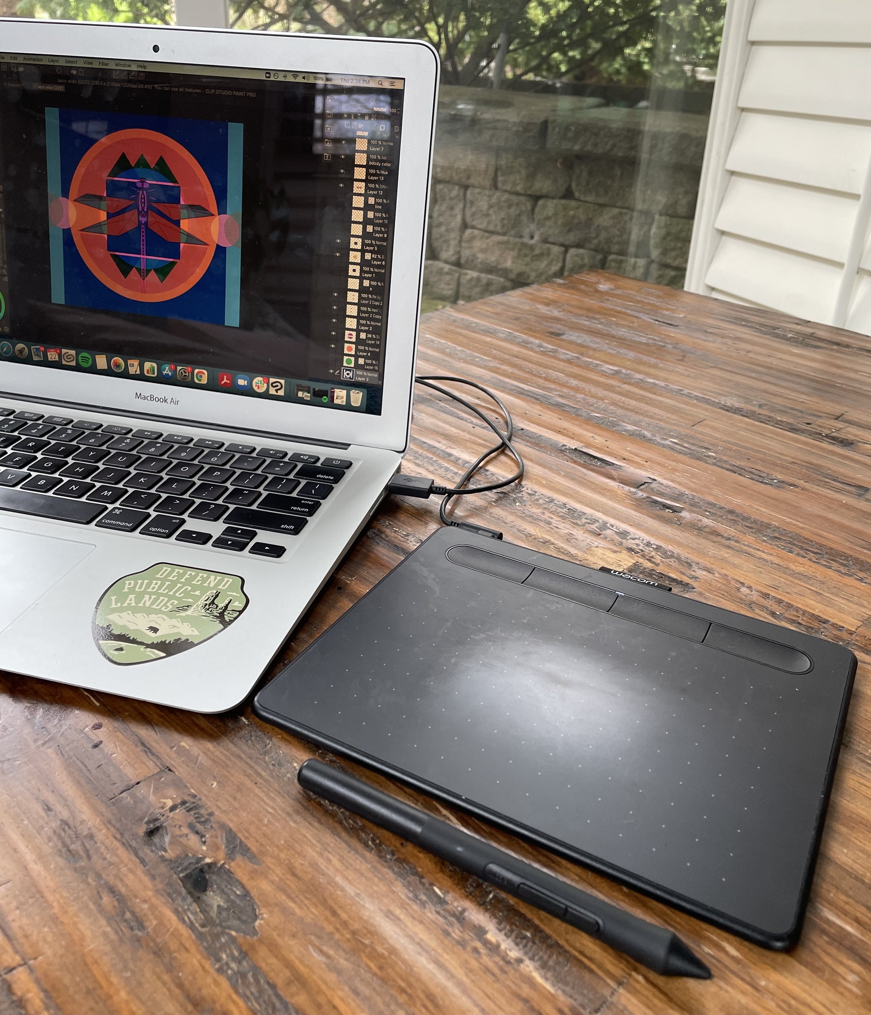 The wacom drawing tablet and stylus plugged into a laptop