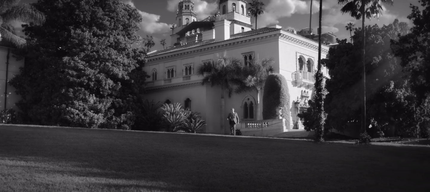 Gary Oldman walking away from a big house in "Mank"