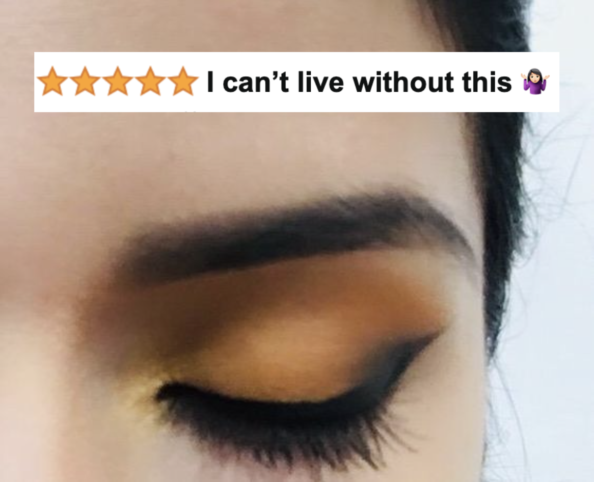 A reviewer photo close up of a winged black liquid eyeliner with five-star caption &quot;I can&#x27;t live without this&quot;