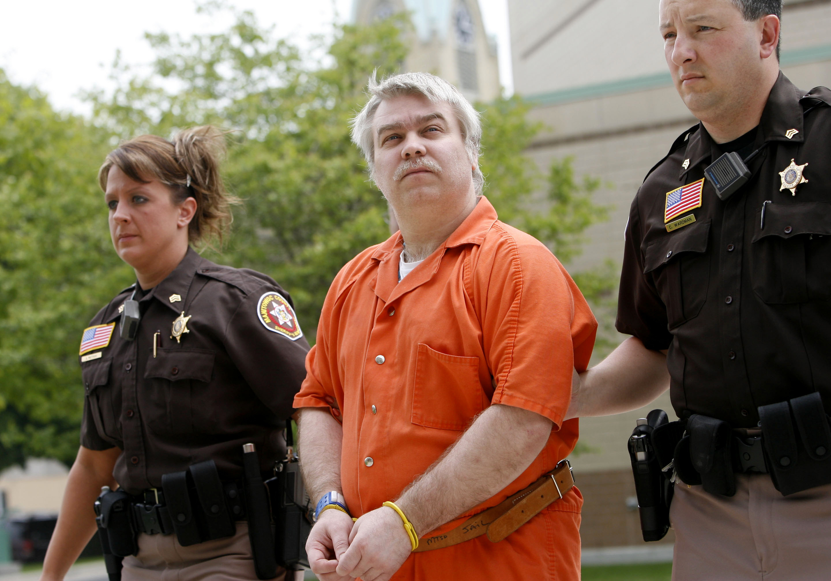Steven Avery being led away from his home in handcuffs by police